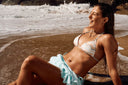 Girl on the sand with a bikini and jewelry 